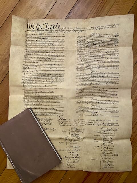 The dust jacket of Signing Their Rights Away fully unfolded, displaying a full-size replica of the United States Constitution. A unique collector's feature of this Quirk Books first edition.