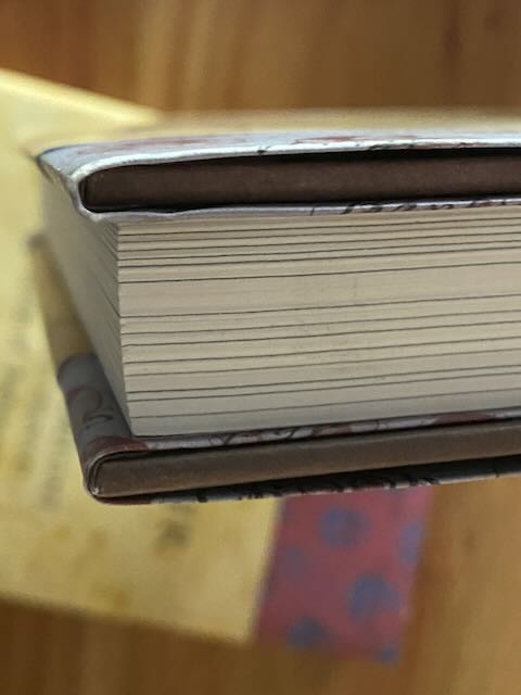 Close-up detail shot of a dust jacket corner showing typical minor box wear from publisher storage. Demonstrates the pristine-to-near-pristine condition of this limited collector's set.
