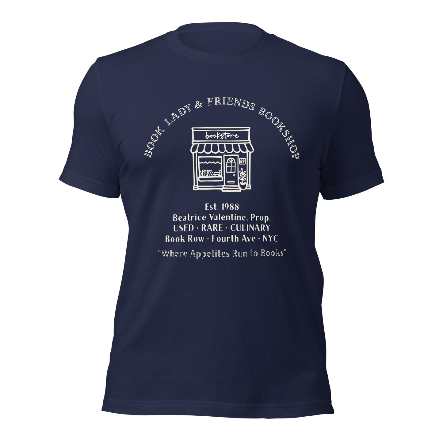 True Royal blue t-shirt featuring a vintage cream-colored design of the 'Book Lady & Friends Bookshop' facade. Includes text: Beatrice Valentine, USED • RARE • CULINARY, Est. 1988, and the motto Where Appetites Run to Books in elegant serif typography.