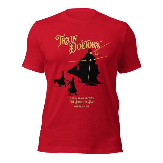 Red t-shirt featuring a black silhouette of a Victorian steam train with trailing cars. Two figures—in a bowler hat and a top hat—stand in front. Gold rays radiate from the train's headlamps, and the text 'Train Doctors' curves above in gold with a white stroke.